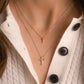 Minimalist cross necklaces in gold layered on model