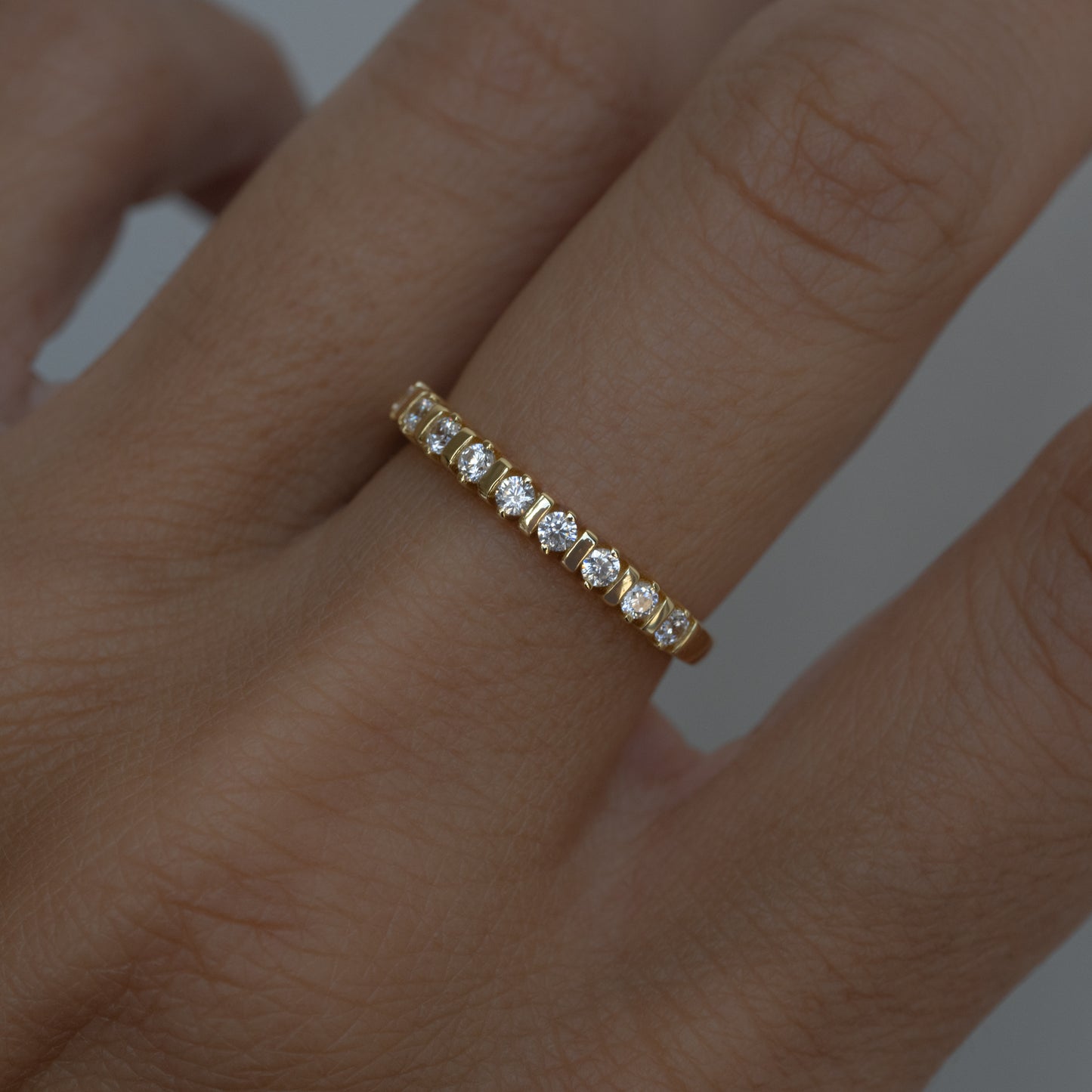 model wearing gold fluted ring with diamonds