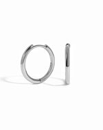 minimalist small sterling silver hoop earrings white background