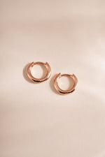 Rose gold Simple Huggie Hoops earrings by Sami Jewels, 8mm flatlay showing minimalist hoop design.