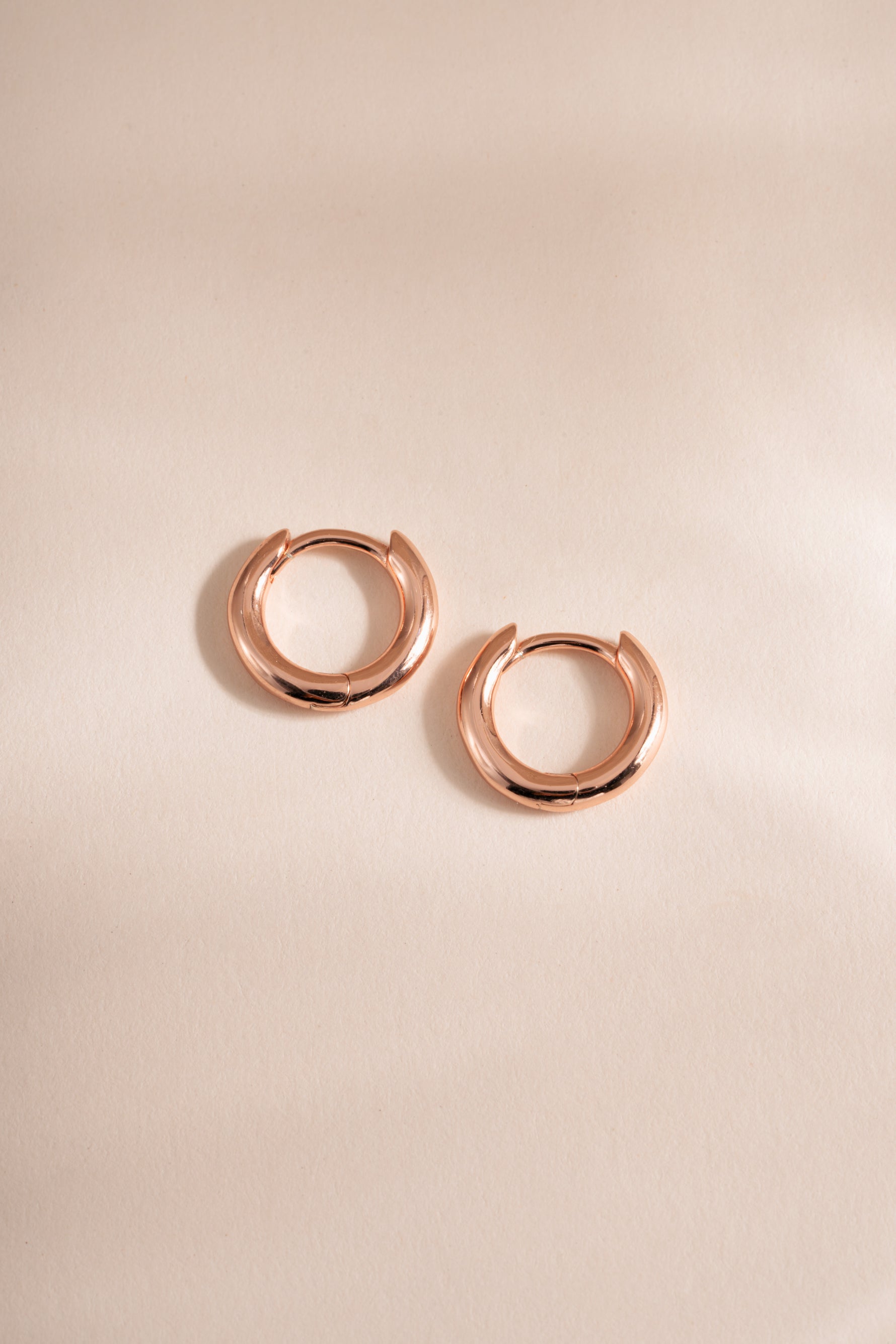 Rose gold Simple Huggie Hoops earrings by Sami Jewels, 8mm flatlay showing minimalist hoop design.