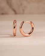 Rose gold 8mm minimalist small hoop earrings by Sami Jewels, shown from a side view on a clean background