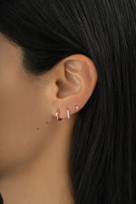 Rose gold Simple Huggie Hoops by Sami Jewels, minimalist earrings shown on a model.