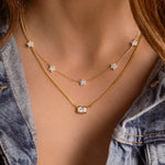 model wearing gold Cuban Chain Necklace with Emerald Cut Pendant, seamlessly paired with diamond jewelry. 