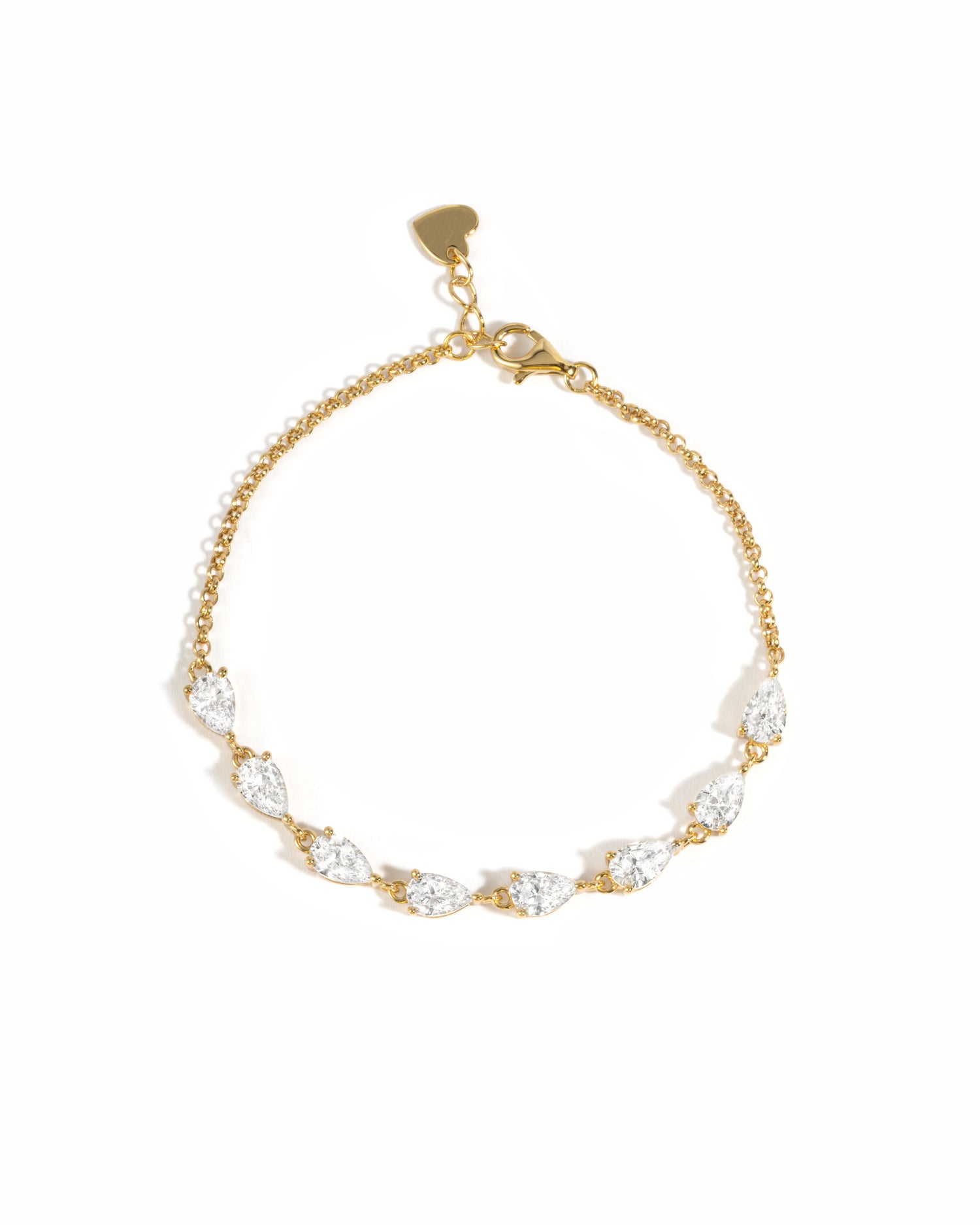 A delicate gold chain bracelet featuring a row of pear-cut cubic zirconia stones in a gold setting, with a small gold heart charm at the clasp, shown on a plain white background.