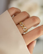 Gold and silver mixed-metal pavé chain ring from Sami Jewels, showcasing intricate design on a model's finger.