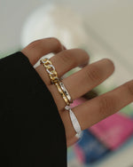 Mixed metal pavé chain ring stacked with other rings, showcasing Sami Jewels' stylish and detailed jewelry design.