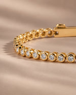 Close-up of the round bezel settings on the moissanite tennis bracelet
