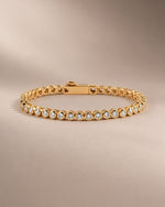 Moissanite round bezel tennis bracelet in gold vermeil with the clasp closed