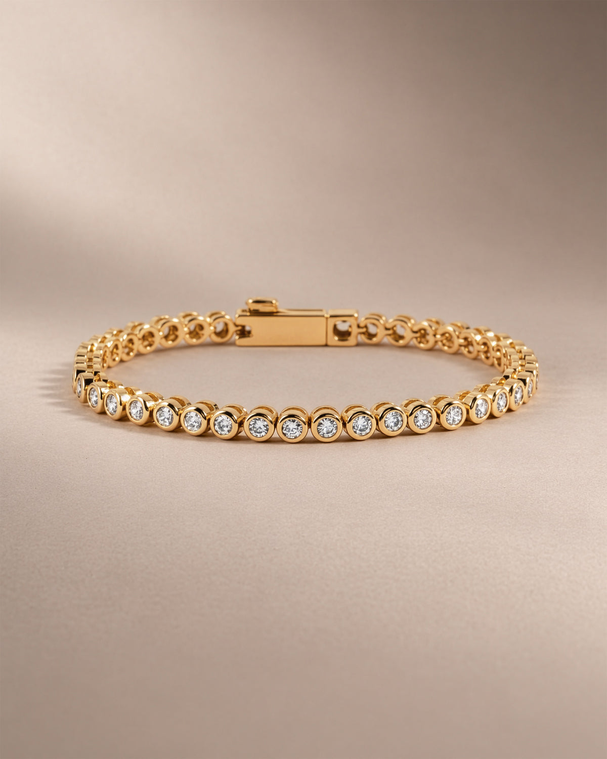 Moissanite round bezel tennis bracelet in gold vermeil with the clasp closed