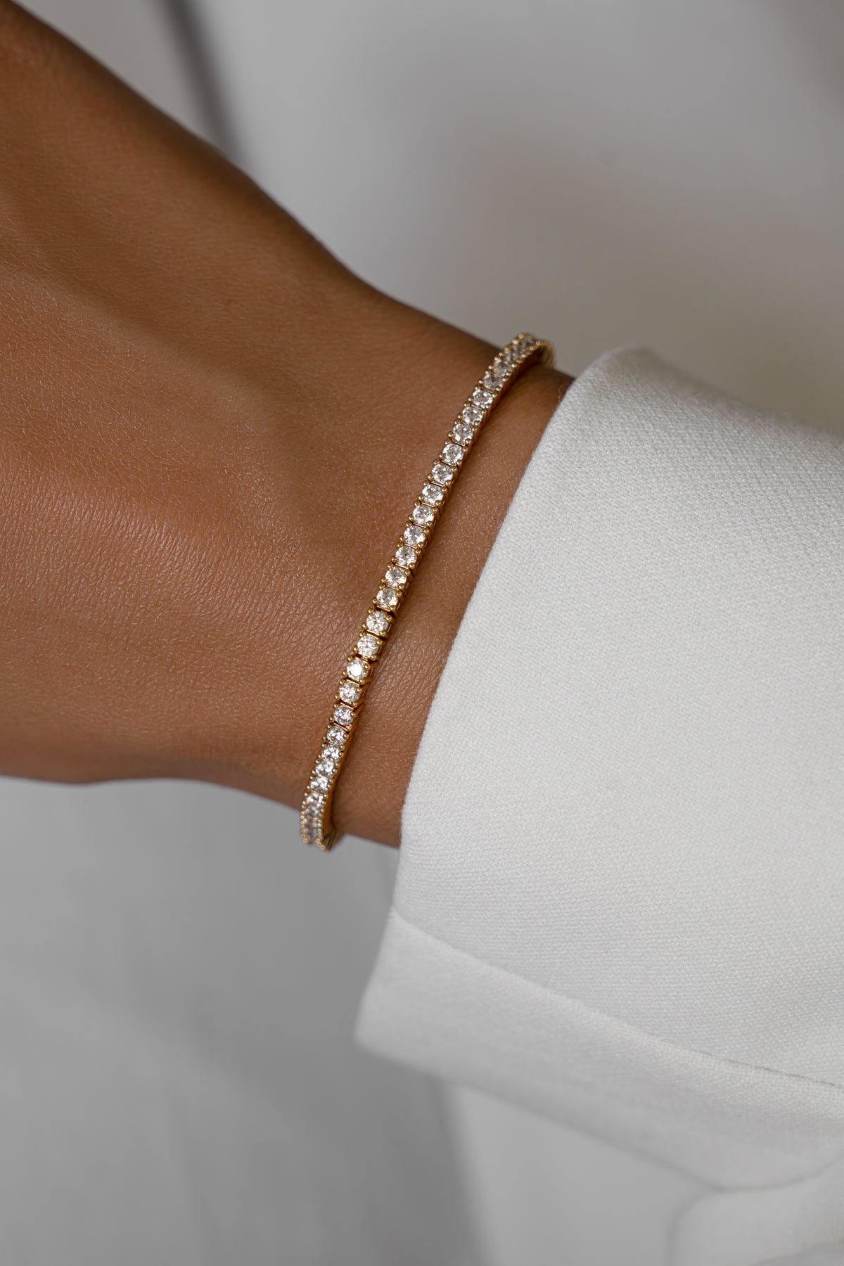 Moissanite tennis bracelet in gold vermeil worn alone on the wrist