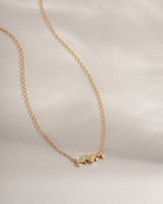 Gold Mom Heart Necklace from Sami Jewels, front view showing a delicate heart pendant engraved with "Mom".