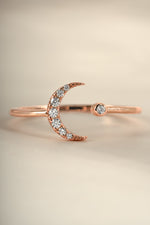 Close-up of Sami Jewels rose gold moon ring with detailed moon design, showcasing elegant craftsmanship and shiny finish.