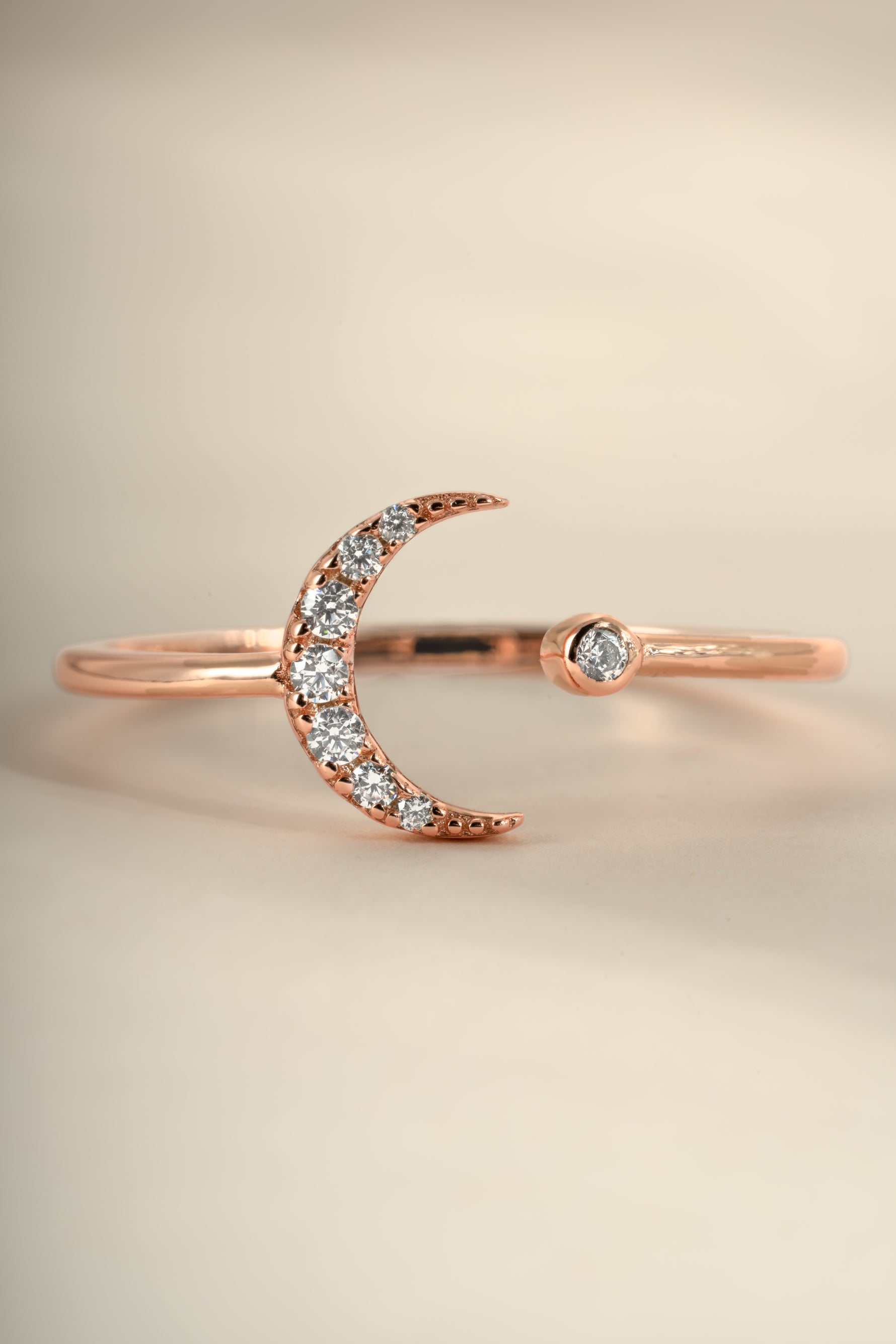 Close-up of Sami Jewels rose gold moon ring with detailed moon design, showcasing elegant craftsmanship and shiny finish.