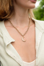 Gold Moon Statement Necklace by Sami Jewels featuring a bold moon design, worn as a stylish accessory in the image.