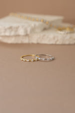 Multi-stone diamond ring by Sami Jewels featuring gold and sterling silver band with sparkling gemstones.