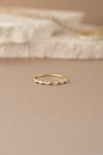Gold multi-stone diamond ring with multiple sparkling stones set in a stylish design, front view showcasing the intricate details.