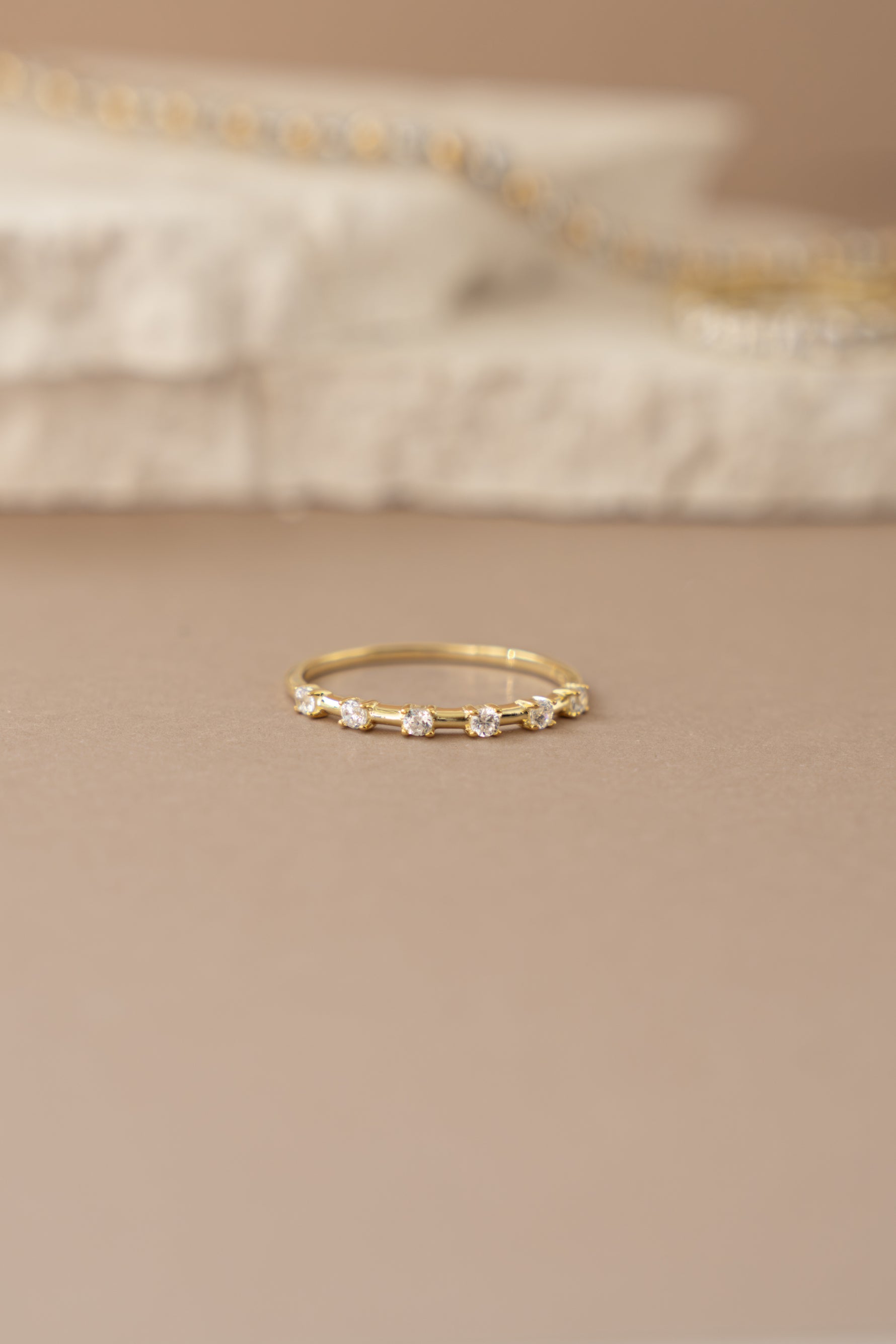 Gold multi-stone diamond ring with multiple sparkling stones set in a stylish design, front view showcasing the intricate details.