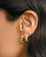Gold multi-stone diamond huggie hoop earrings by Sami Jewels featuring colorful gemstone accents and a sleek hoop design.