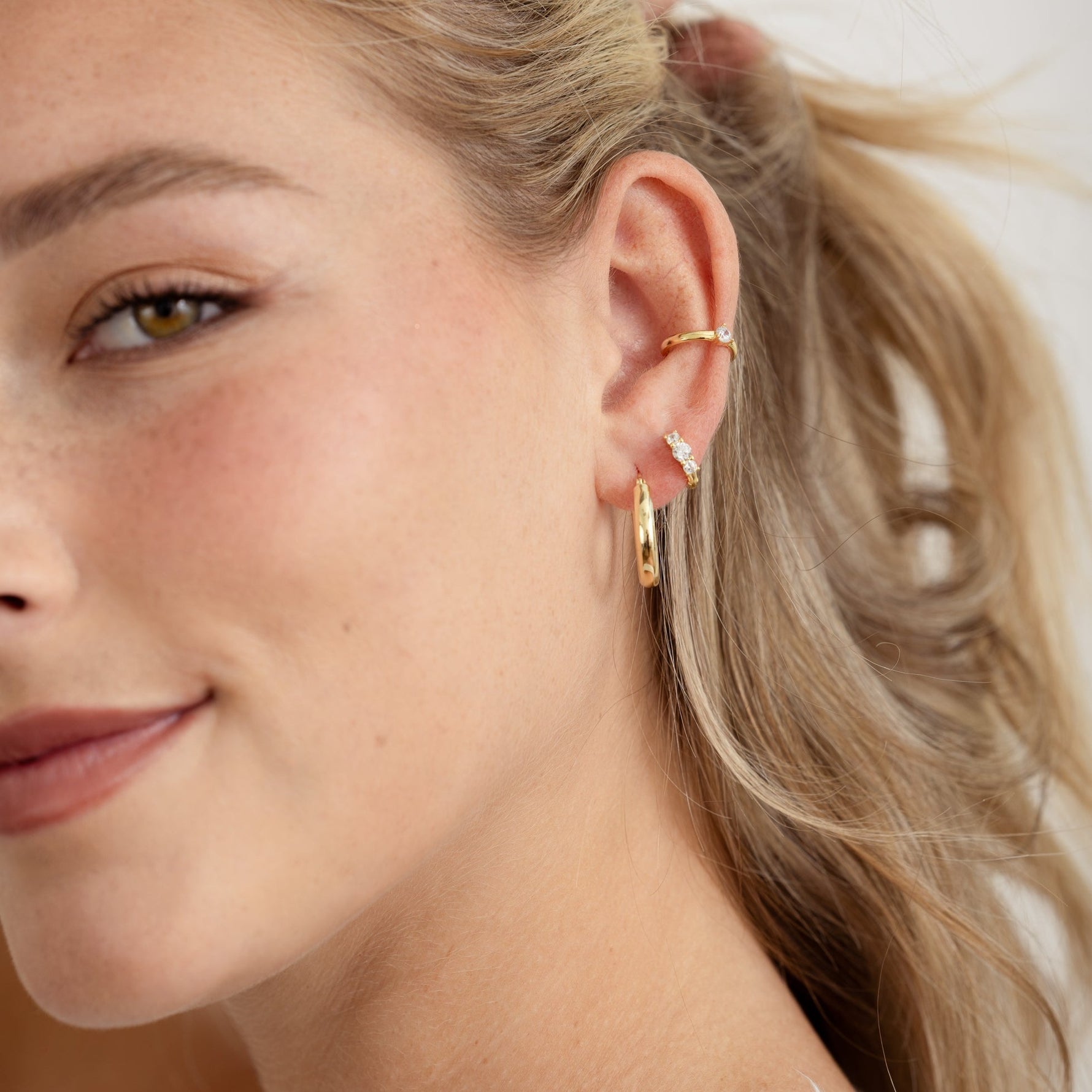model weaing hoops, small diamond hoops and a dainty ear cuff