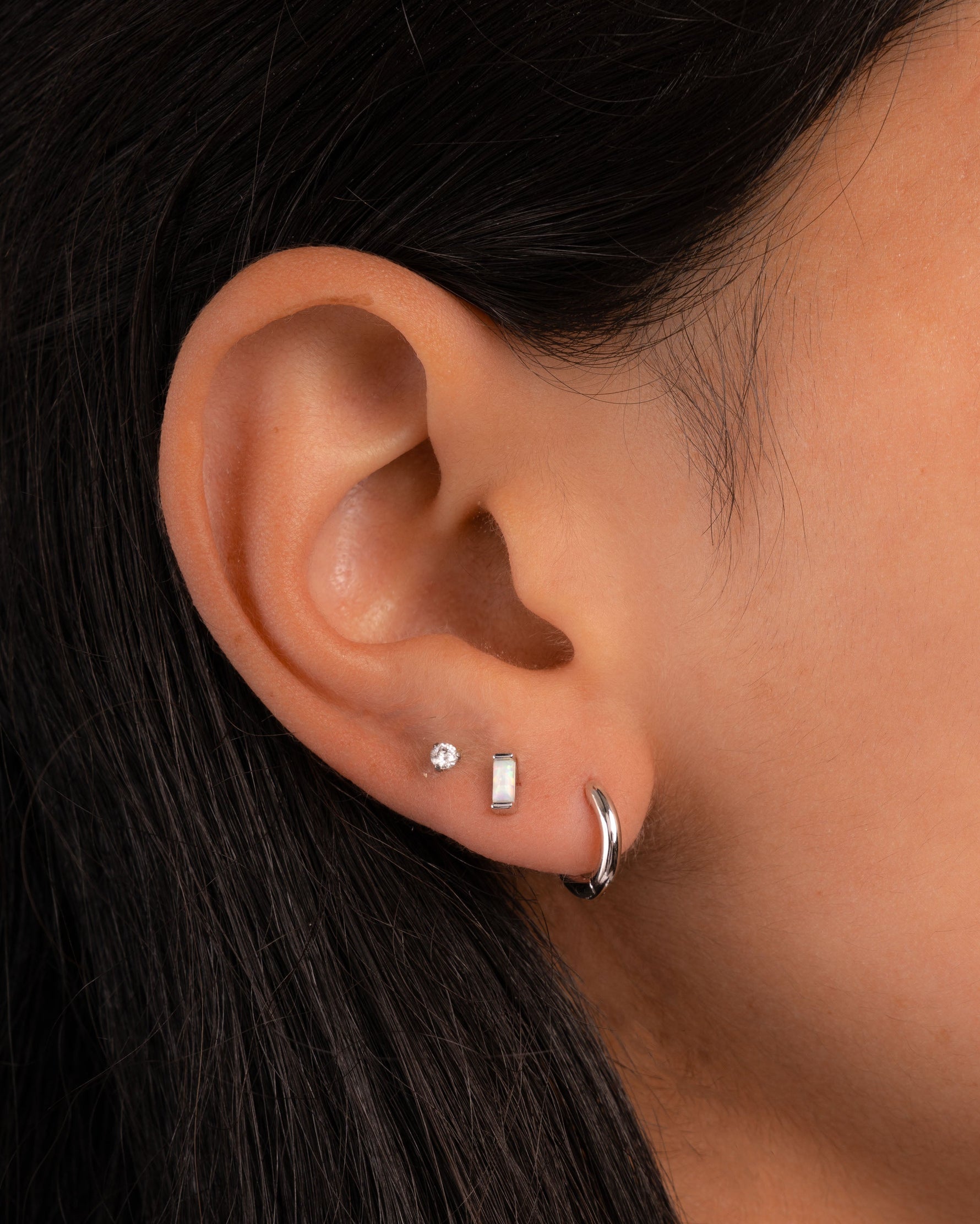 Sami Jewels opal baguette stud earrings featuring rectangular white opal gemstones set in silver or gold metal.