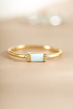 Close-up of Samijewels-527 Opal Baguette Ring featuring a gold band and a central rectangular opal gemstone.