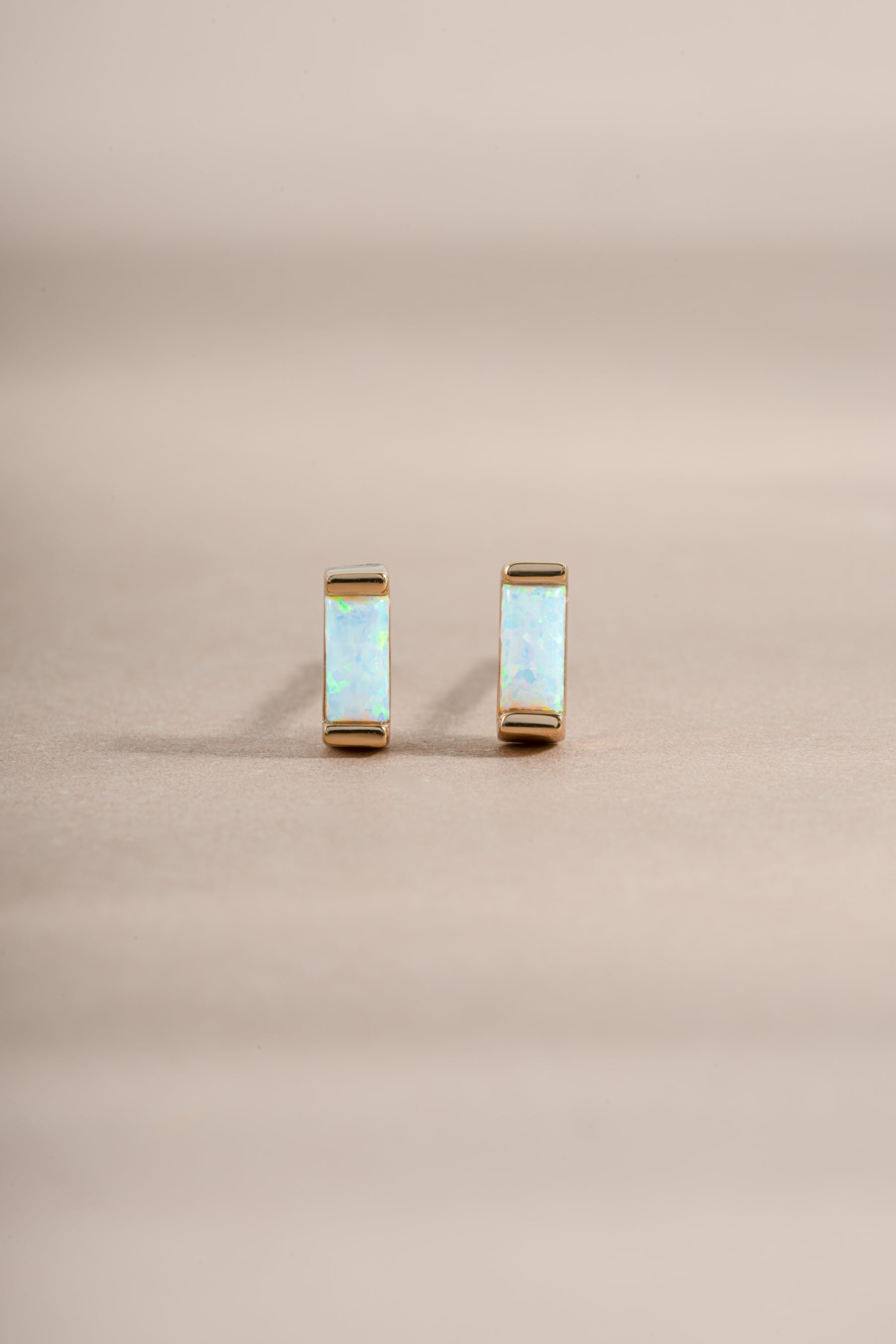 opal baguette studs in gold on front view