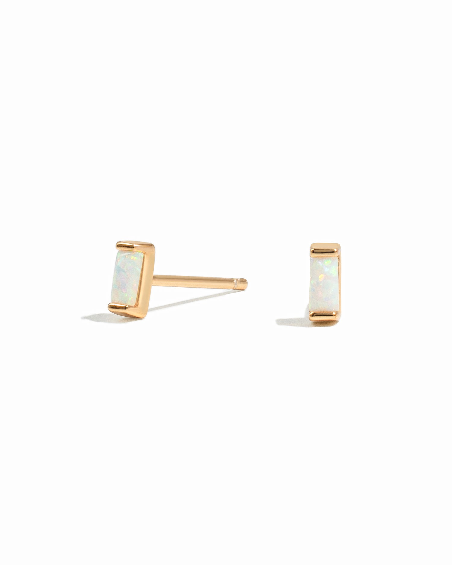 opal baguette studs in gold on a white background 