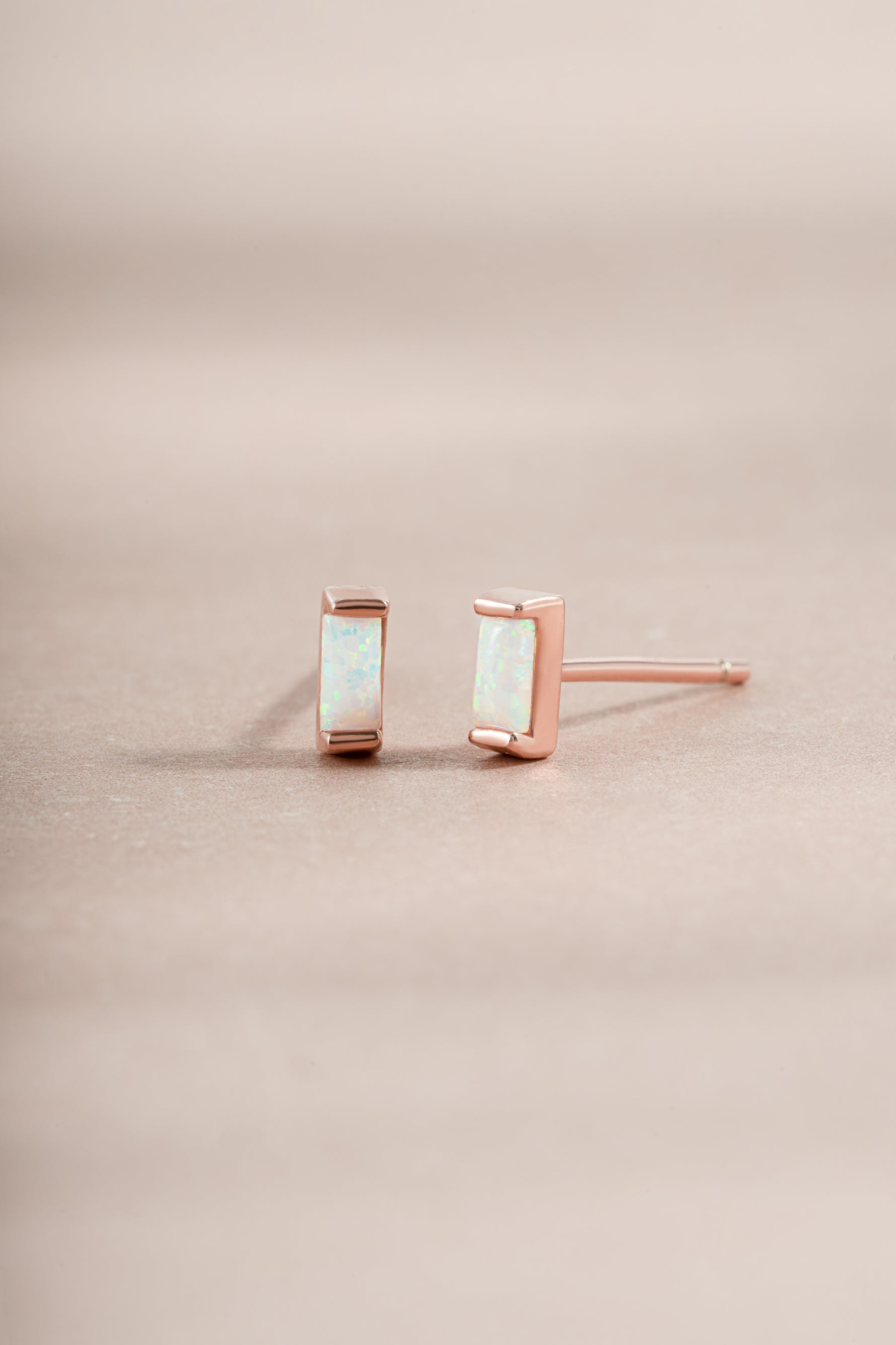 opal baguette stud earrings in role gold on neutral background
