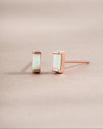 Rose gold Sami Jewels opal baguette stud earrings with sleek, rectangular gemstone design on a white background.