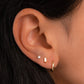 closeup of gold earrings featuring opal earrings 