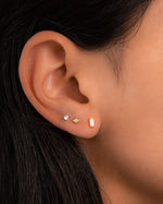 opal baguette studs in gold on models ear
