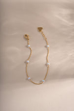 Close-up of Sami Jewels opal beaded bracelet with gold accents, showcasing smooth round opal beads and elegant gold details.