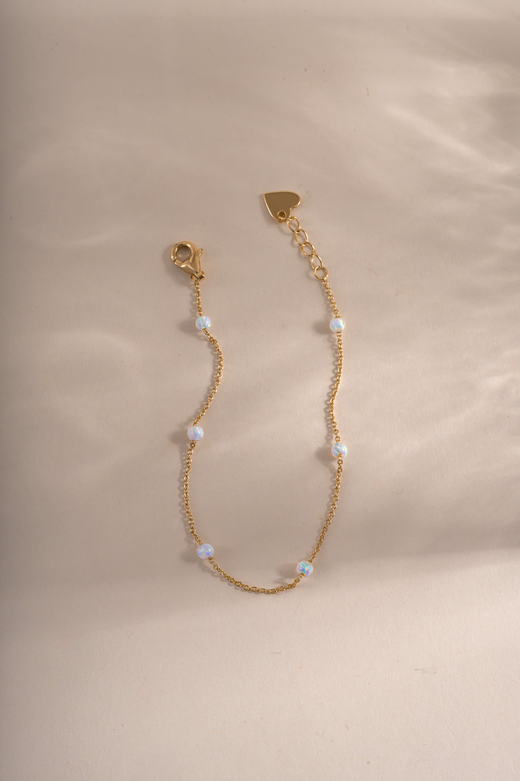 Close-up of Sami Jewels opal beaded bracelet with gold accents, showcasing smooth round opal beads and elegant gold details.