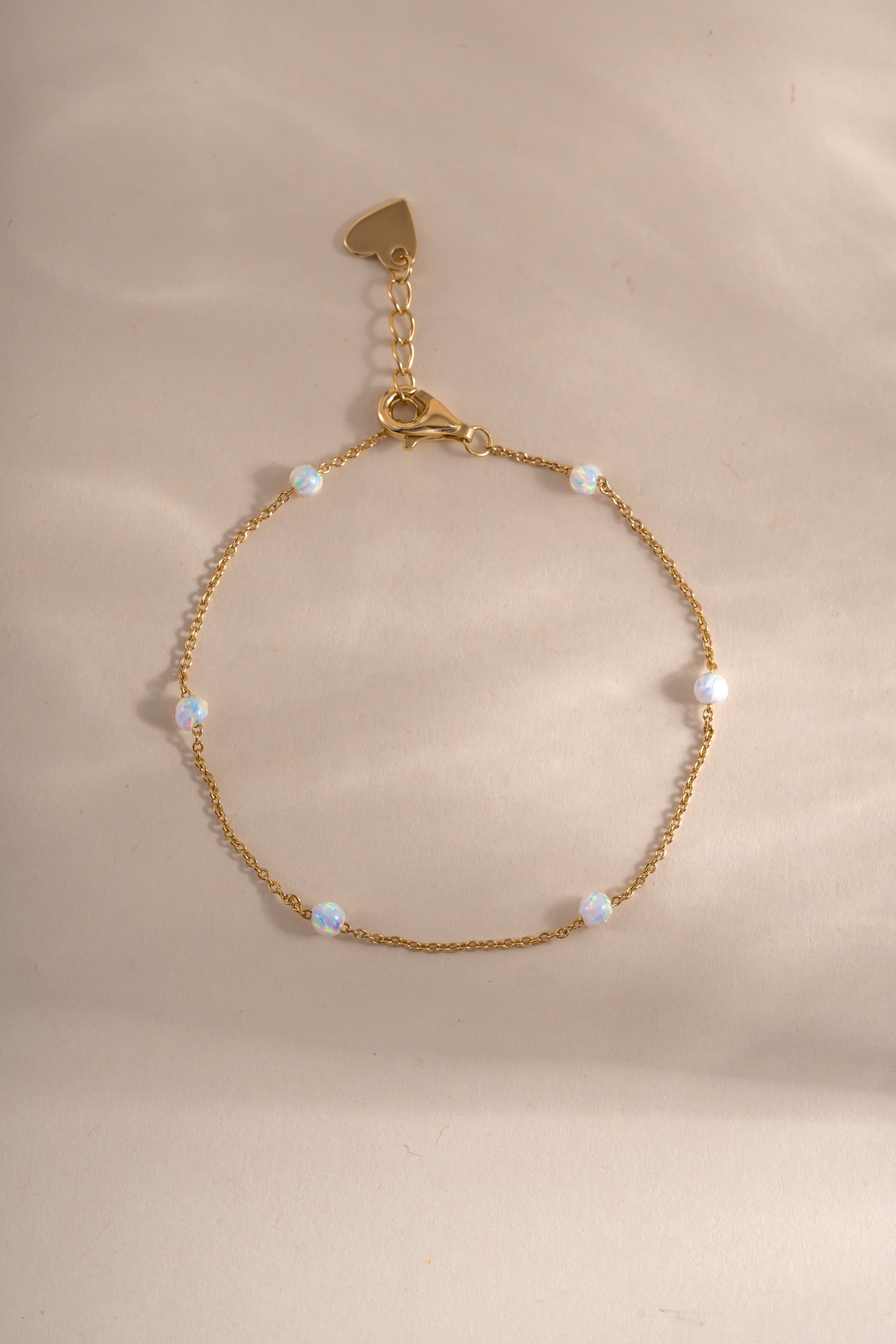 Gold opal beaded bracelet by Sami Jewels displayed in a flatlay with shiny round beads and delicate design.