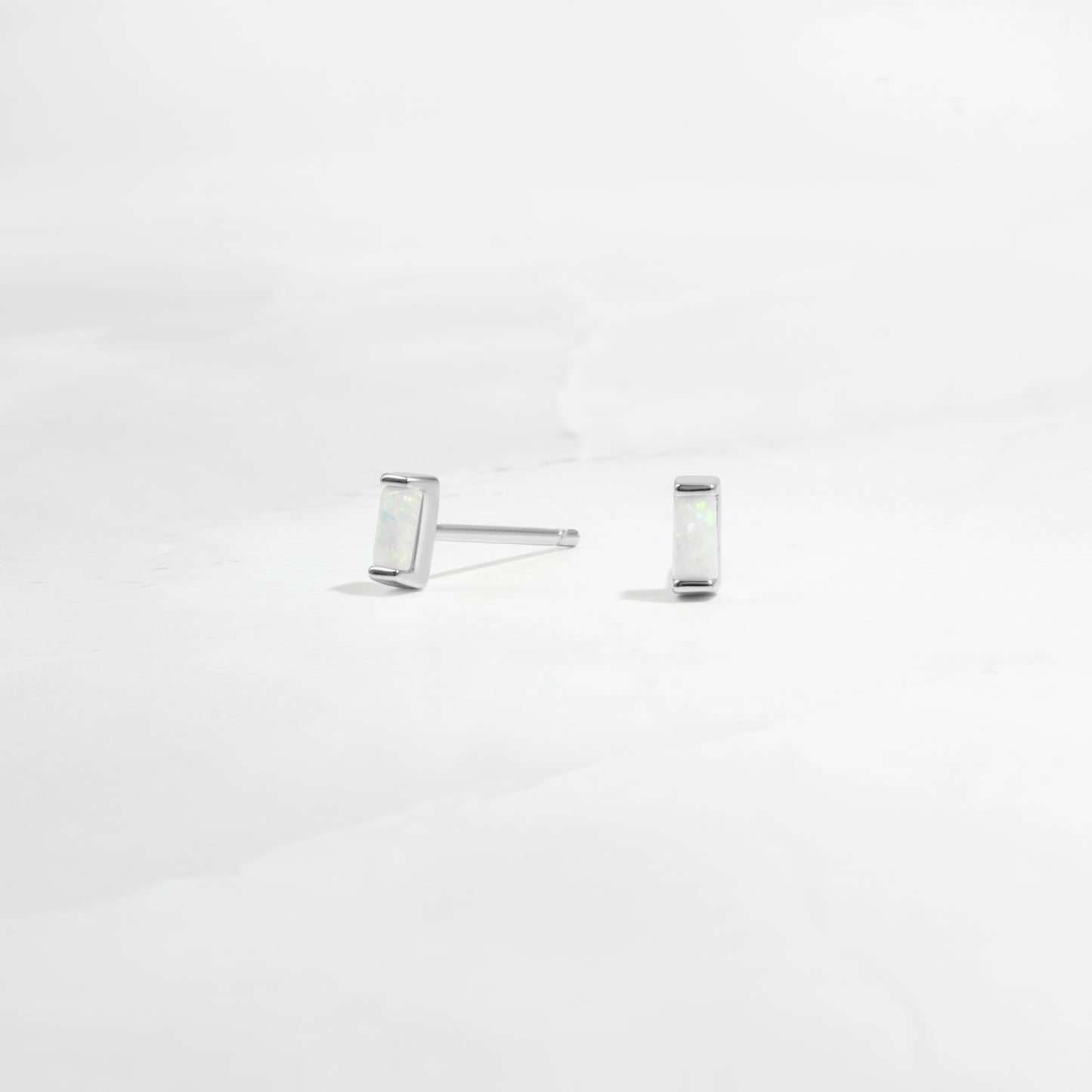 closeup of silver opal earrings 