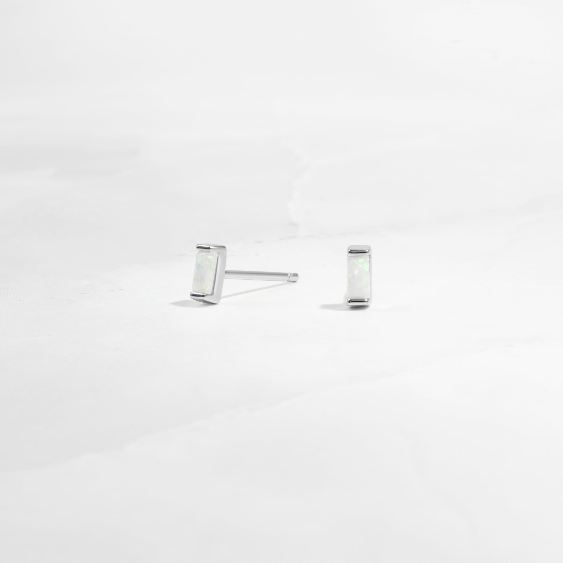 closeup of silver opal earrings 
