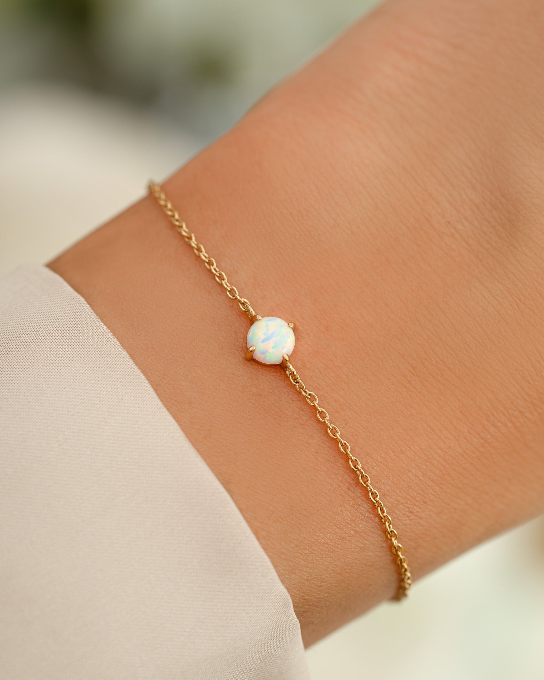 opal bracelet in gold on models wrist