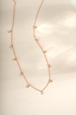 Rose gold Opal and cubic zirconia charm necklace from Sami Jewels showing the delicate pendant with sparkling stones.