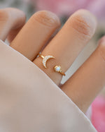 Gold Opal and CZ Moon Ring by Samijewels-527, featuring a moon-shaped design on a model's hand.