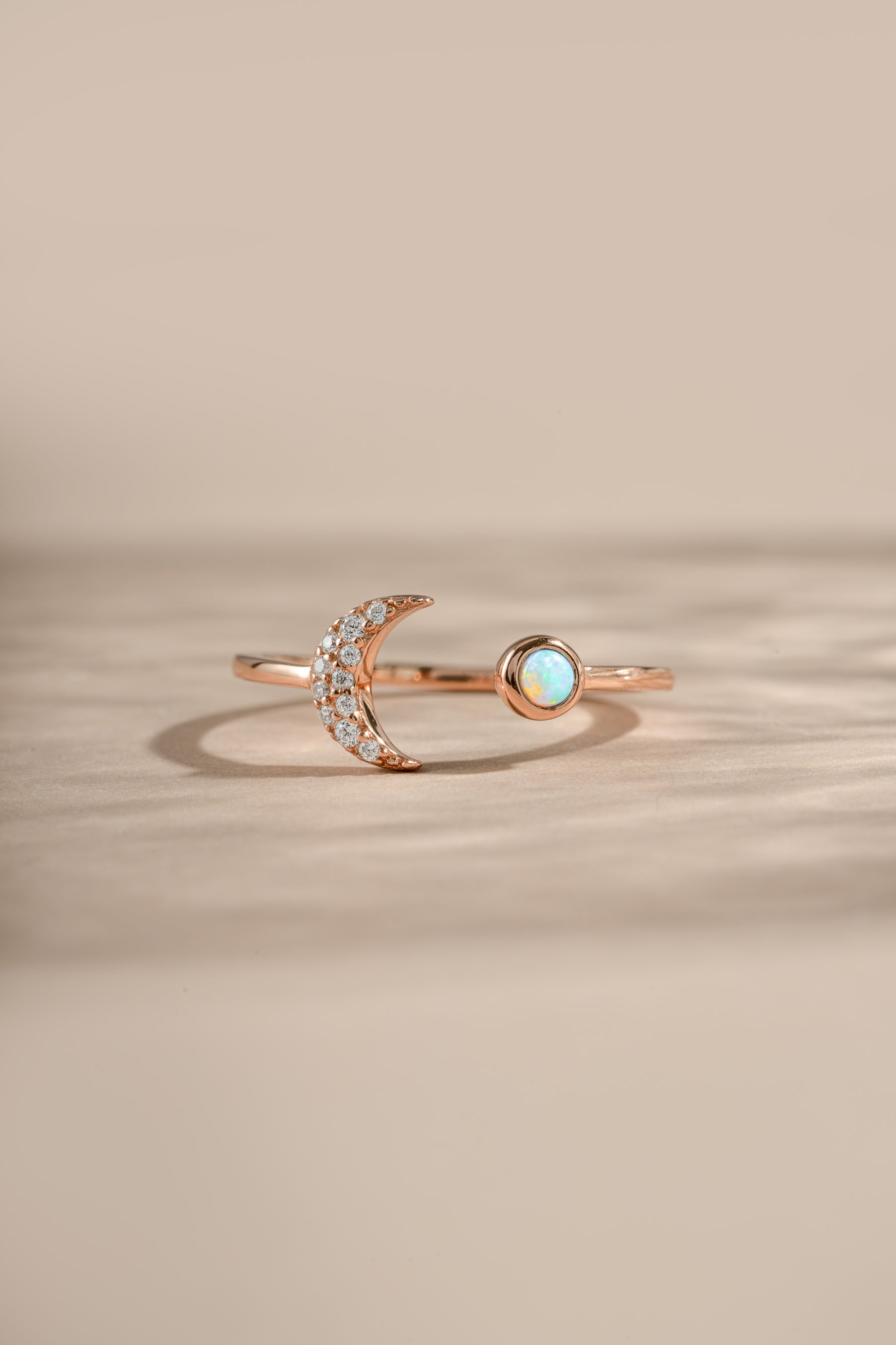 Rose gold Opal and CZ moon ring by Samijewels-527 featuring a moon-shaped design with sparkling stones and a polished finish.