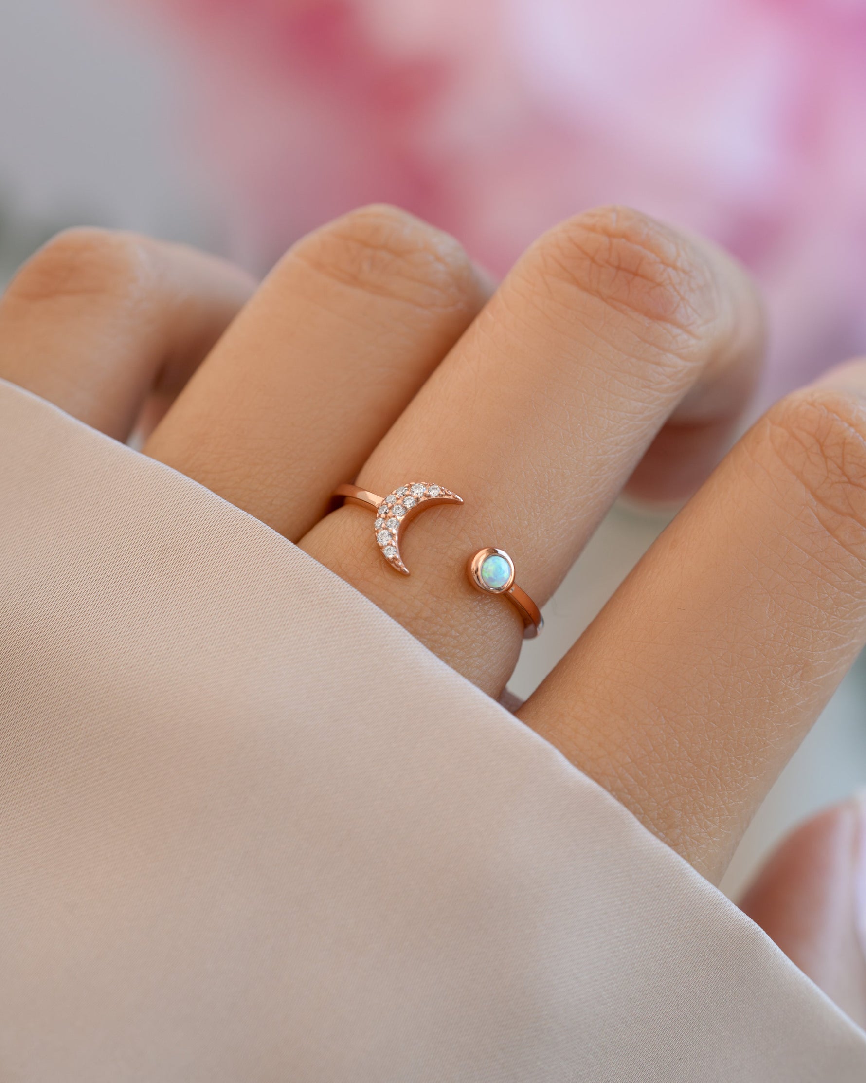 Rose gold Opal and CZ moon ring from Samijewels-527 worn on a model's finger, showcasing a celestial-inspired design.