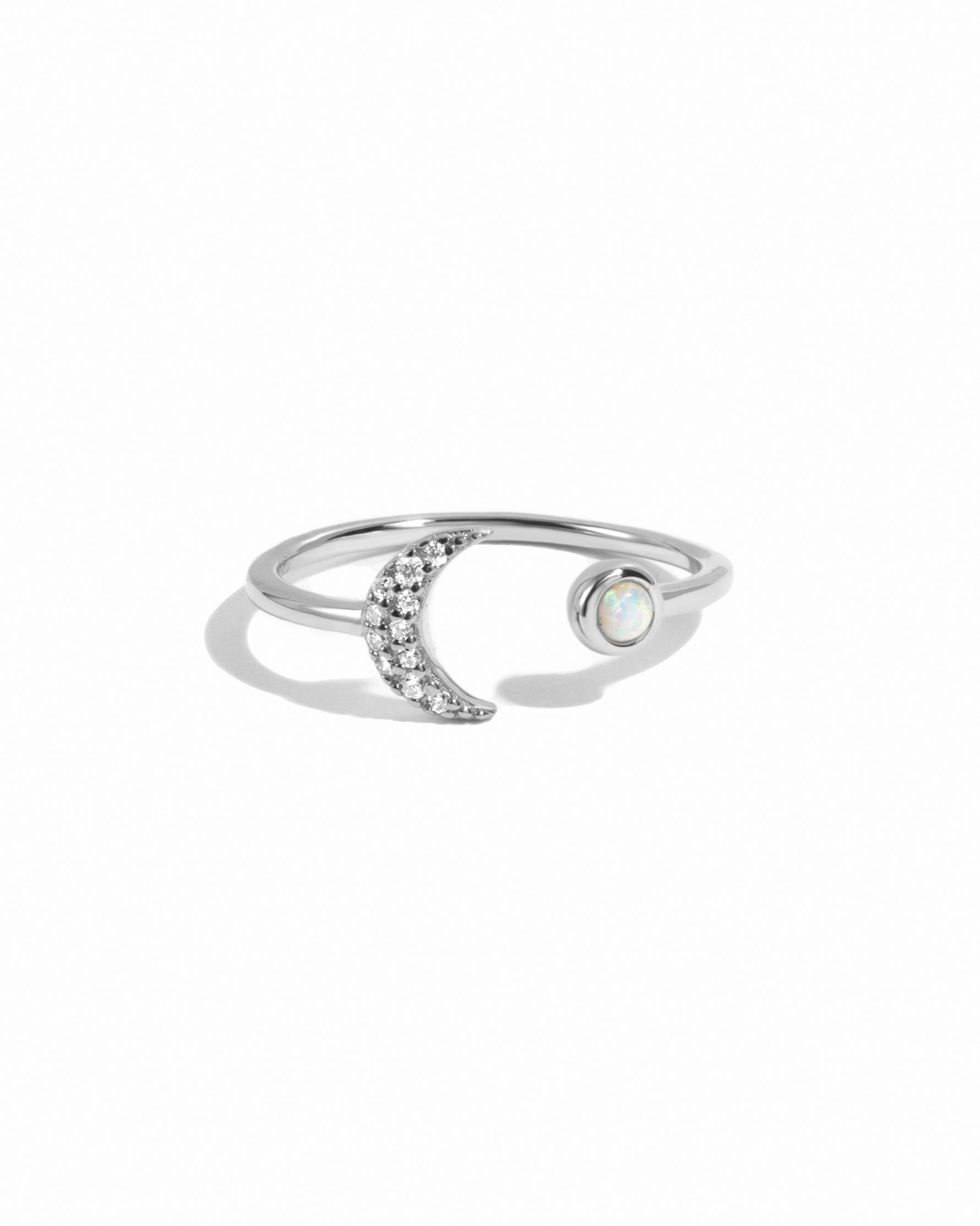 Sterling silver Opal & CZ Moon ring with a detailed moon design and sparkling stones, displayed on a white background.
