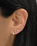 Gold opal ear climber earring styled on a model, showcasing elegant jewelry design by Sami Jewels.