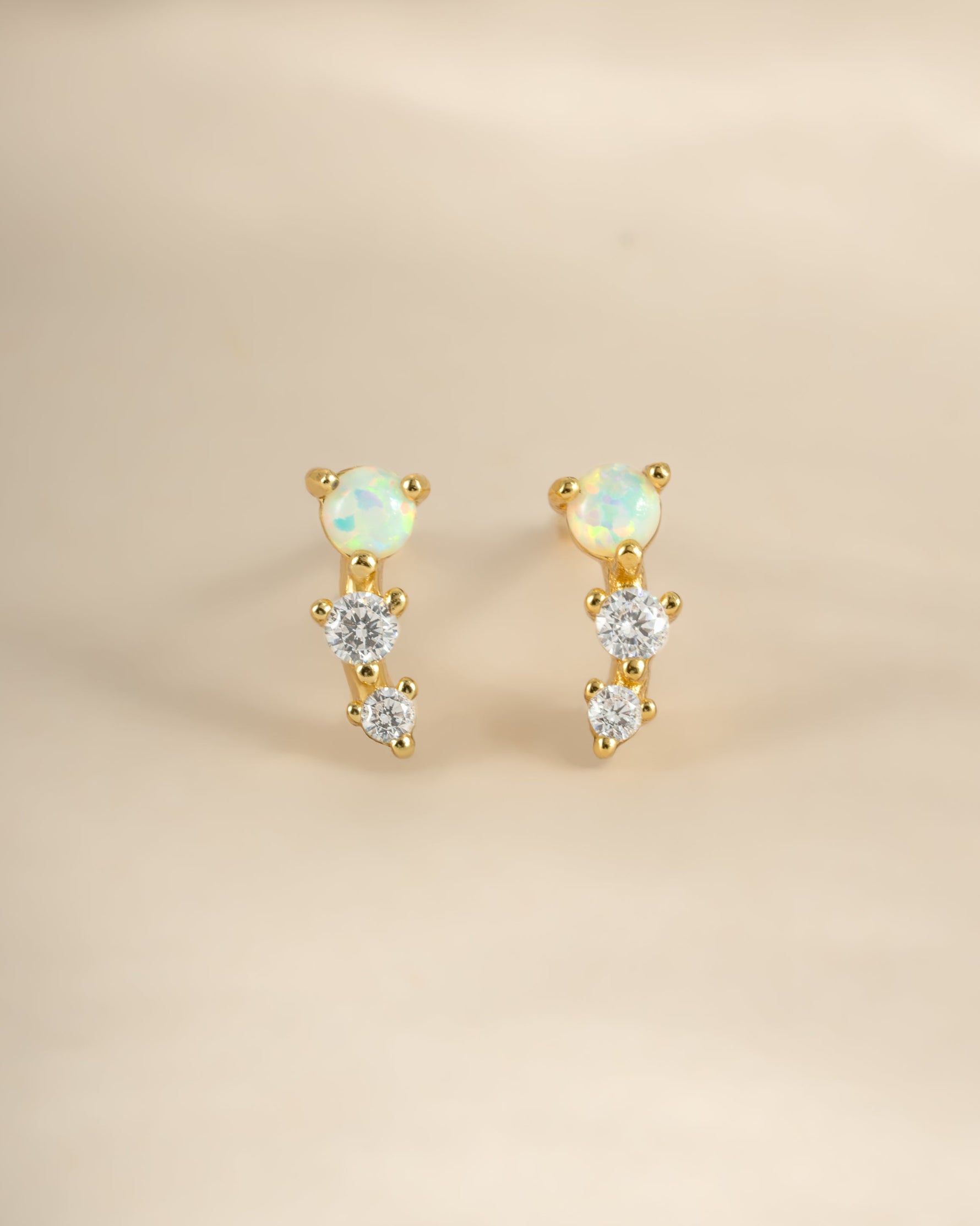 Gold opal ear climber earrings by Sami Jewels, front view showing elegant design and sparkling opal stones.