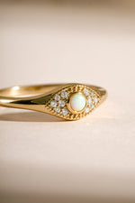 Close-up of Sami Jewels Opal Evil Eye Ring in gold, showcasing the detailed evil eye design with opal gemstone on a ring.