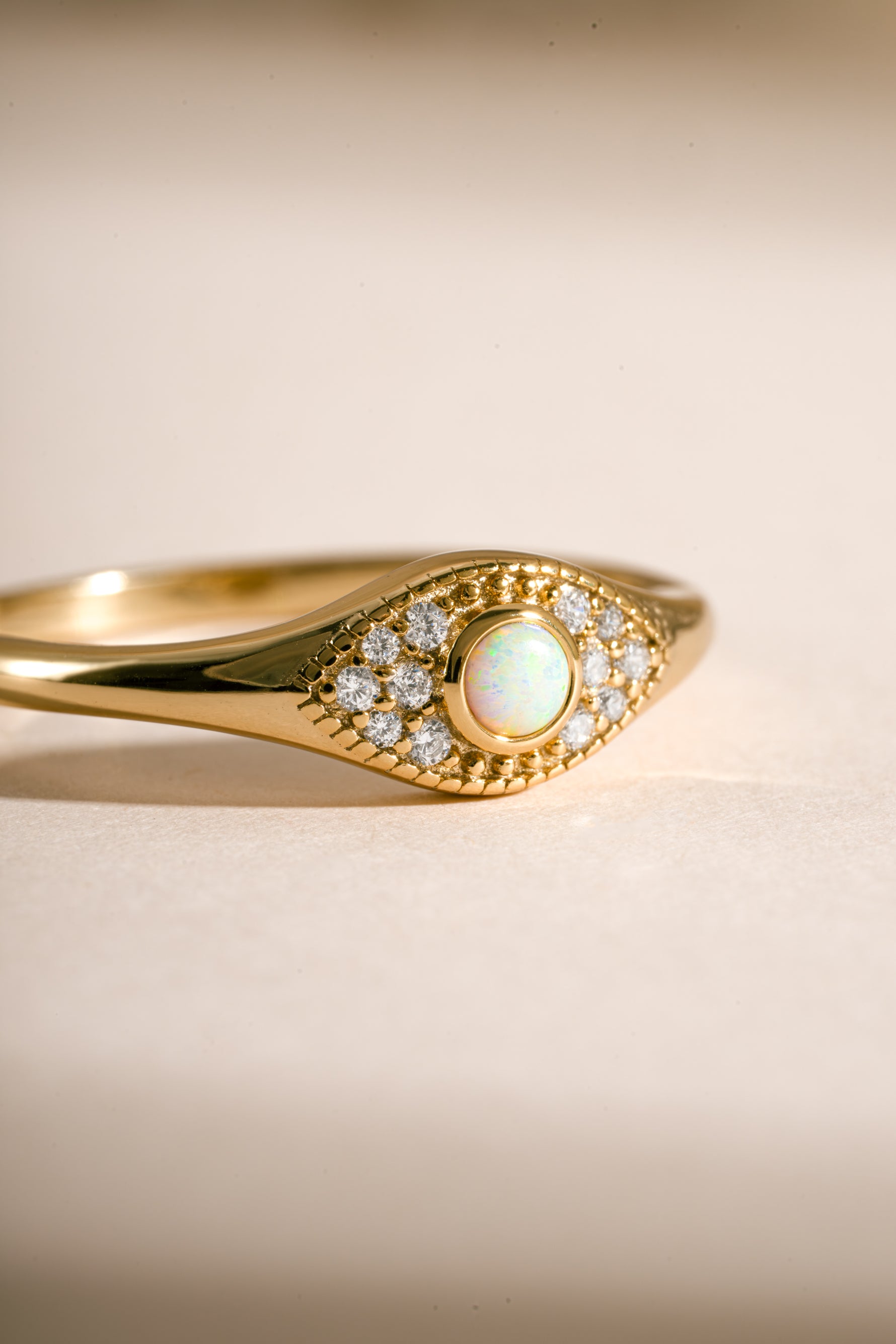 Close-up of Sami Jewels Opal Evil Eye Ring in gold, showcasing the detailed evil eye design with opal gemstone on a ring.