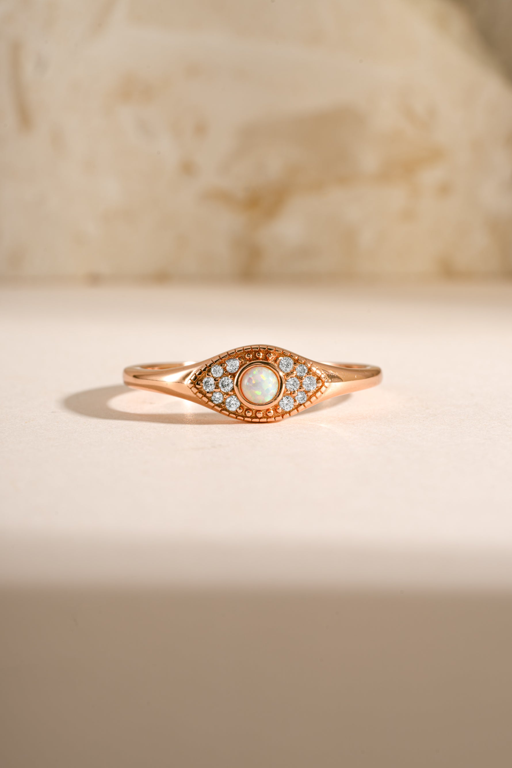 Rose gold Opal Evil Eye Ring by Sami Jewels featuring a polished opal centerpiece and detailed evil eye design.