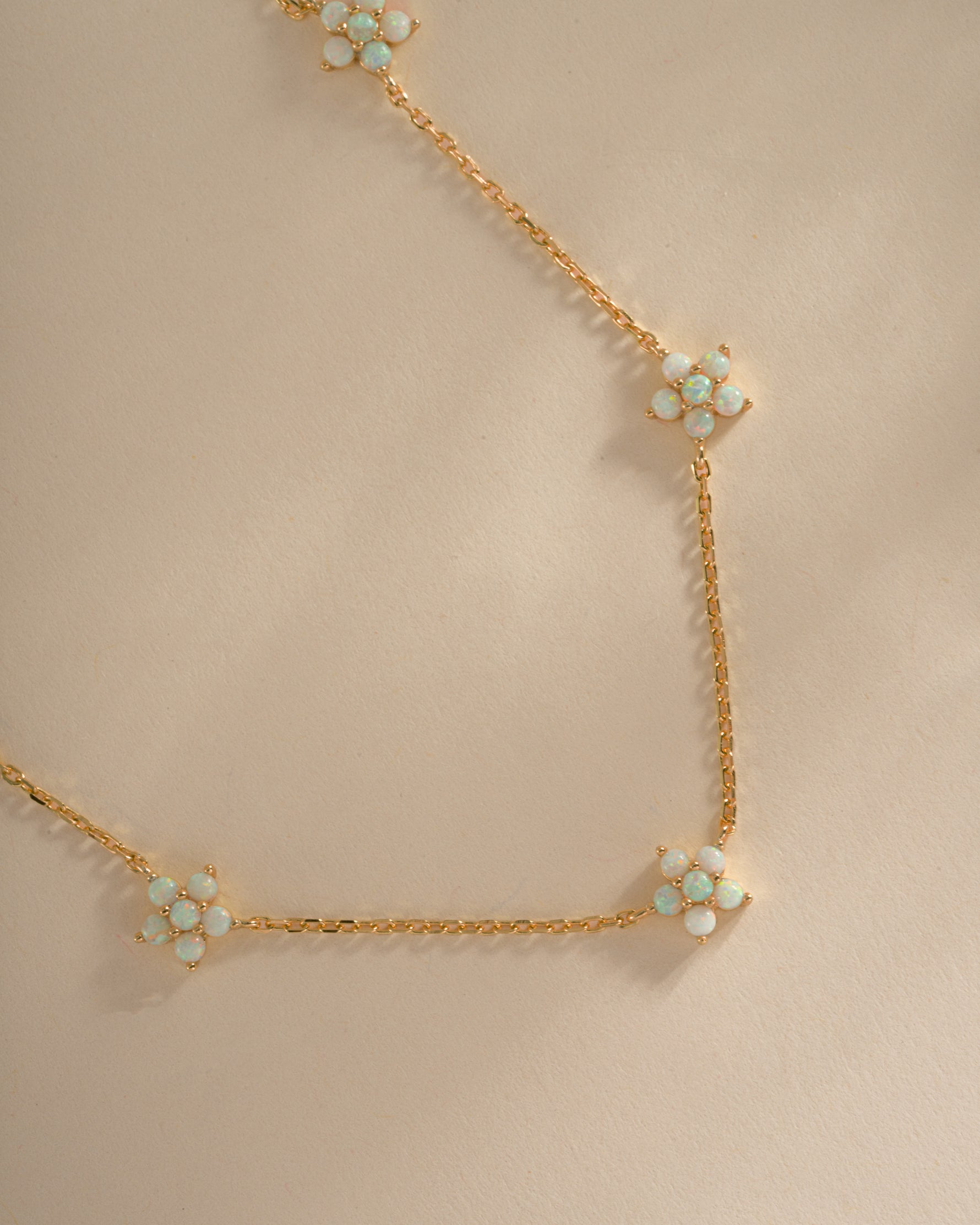 Close-up of Sami Jewels Opal Flower Charm Necklace featuring a delicate gold chain and an elegant opal flower pendant.