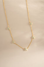 Gold Opal Flower Charm Necklace from Sami Jewels, featuring a delicate floral pendant on a fine chain.